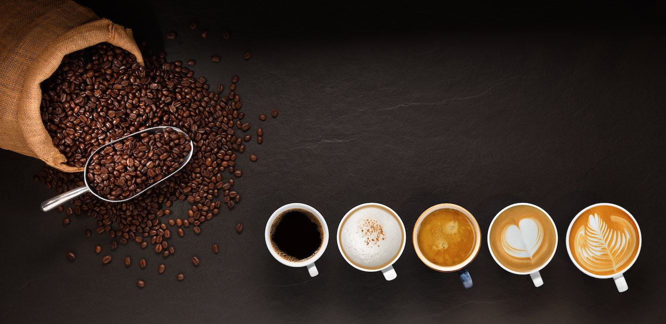 Picture of coffee beans and different cups of coffee ranging from black coffee to lattes